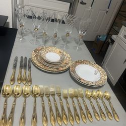 Elegant Flatware And Gold-accented Wine Glasses