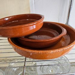 vintage Spanish terracotta cazuela dishes, commonly used for cooking and serving tapas or paella.