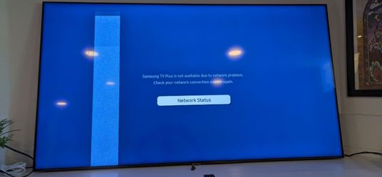 70" samsung qled smart tv with remote and legs works but has a band on side of screen