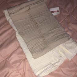 two tan and beige baby swaddles 