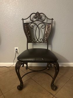 Ornate Wrought Iron Chair with Cushioned Seat