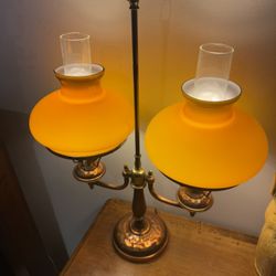 Antique double-arm brass student lamp with butterscotch glass