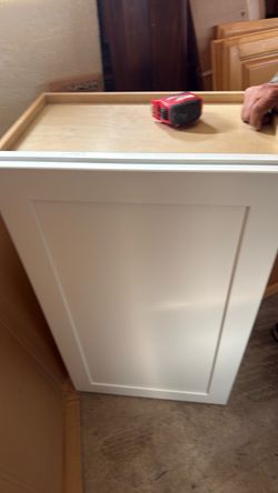 Dove white kitchen cabinet 2 floor ones and one top over the refrigerator