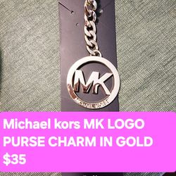 Normal Wear Great Condition Michael kor MK logo purse charm in gold .
.