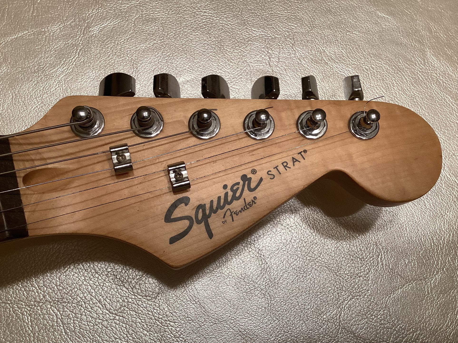 Fender Squier Electric Guitar With White Pickguard.
