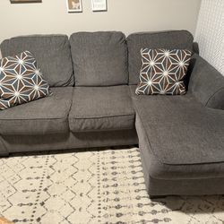 Dark gray sofa w/ reversible chaise + 2 throw pillows