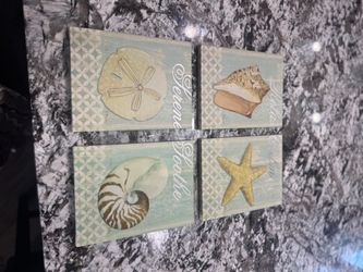 Four beach themed small canvases