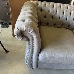 Love Seat sofa with studded armrest.