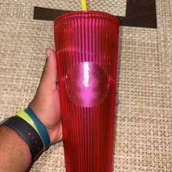 Pink starbucks cup with green straw 