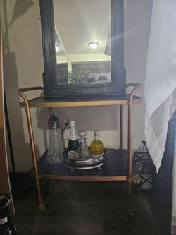 Large mirror and gold cart