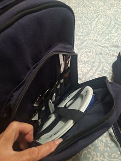 Insulated back pack with plates and silverware  bottle opener and a cutting board and dice.   Great gift  12 dollars
