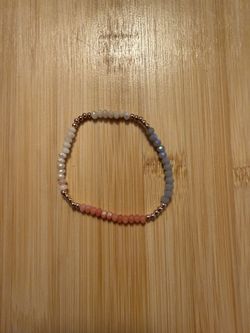 Multicolored beaded bracelet with gold accents.