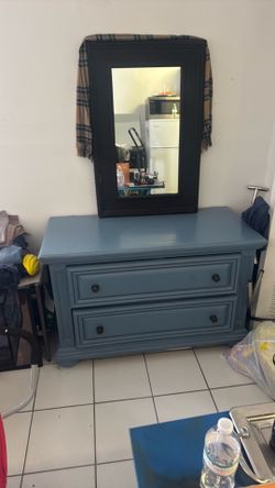 45 x 29 1/2 blue dresser with 36 inch high by 24 white black mirror