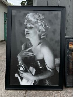 framed black-and-white print poster of Marilyn Monroe applying Chanel No. 5 perfume