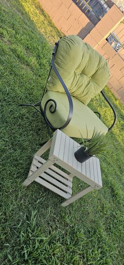 **Wrought Iron Patio Chair with Cushions and Side Table**