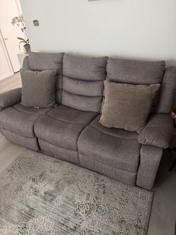 Gray living room sofa with leg rests