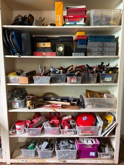 Assorted tools including screwdrivers, fasteners, saw blade, sander