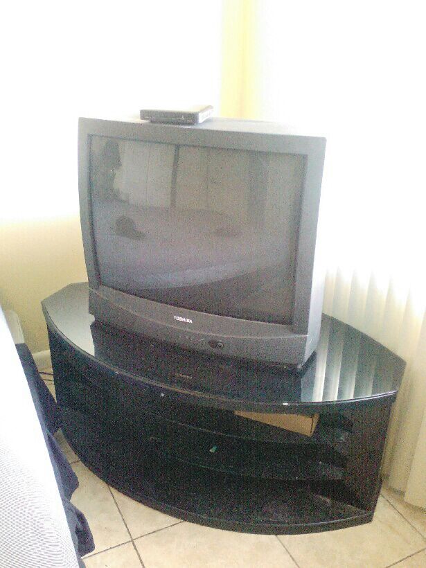 Toshiba 36 inch fat back TV and black and glass TV stand