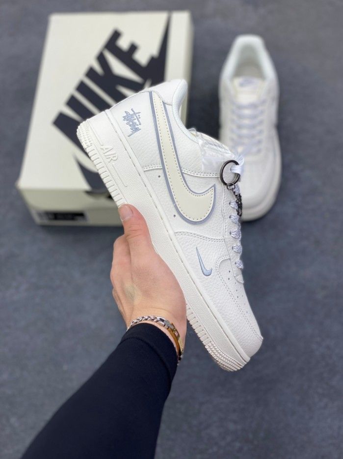 Stüssy and Nike Air Force 1: Elegant All-White Sneakers with Subtle Light Blue Accents and Unique Design Details