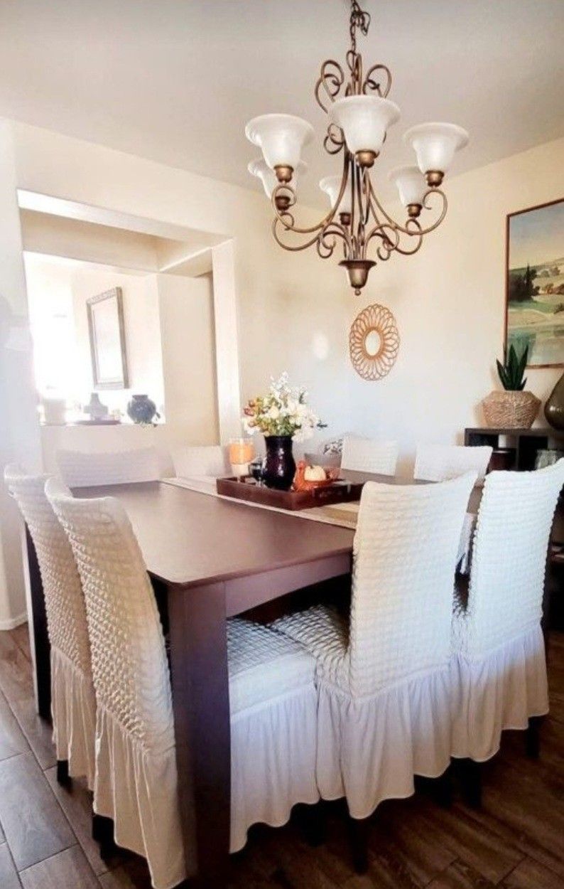 Large wood dining room table with 6 chairs.