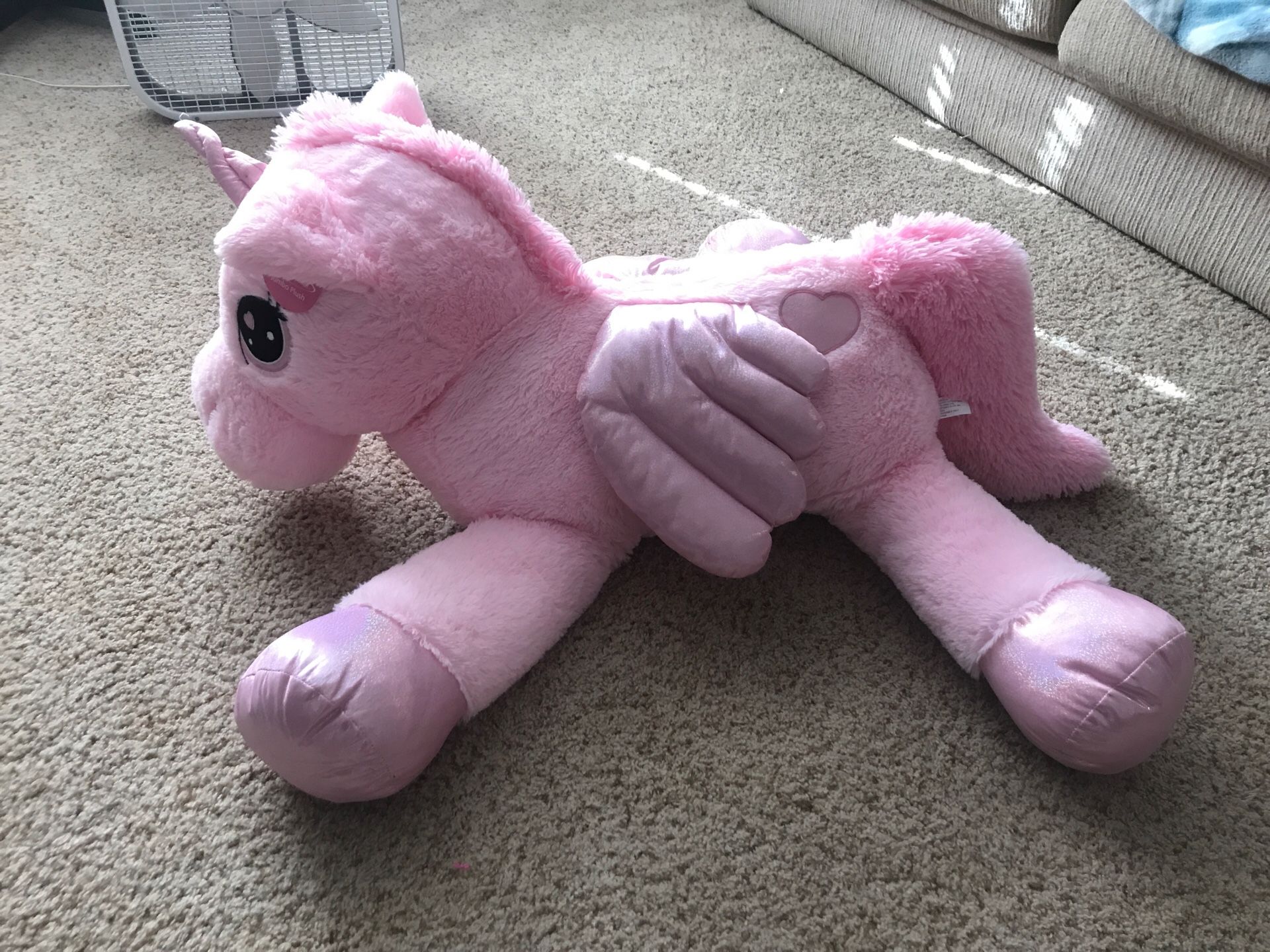 Giant pink unicorn stuffed animal