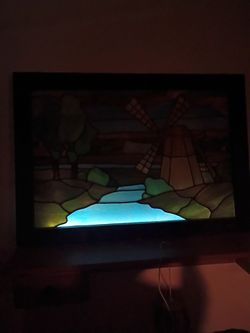 Antique Multiconder stained glass picture of home.