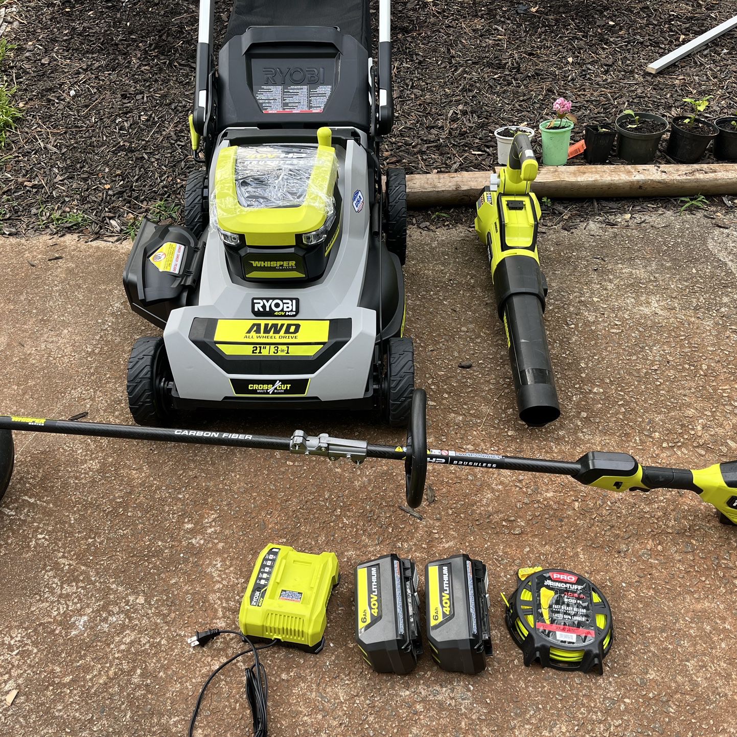 Ryobi 40 V 21 inch all whisper series, wheel drive self-propelled mower string trimmer leaf blower two batteries, one charger 400