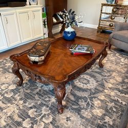 Coffee Table ornate carved scrollwork apron and curved cabriole legs w claw feet 53” x 35” x 19” tall Few scratches and minor wear. Very sturdy and st