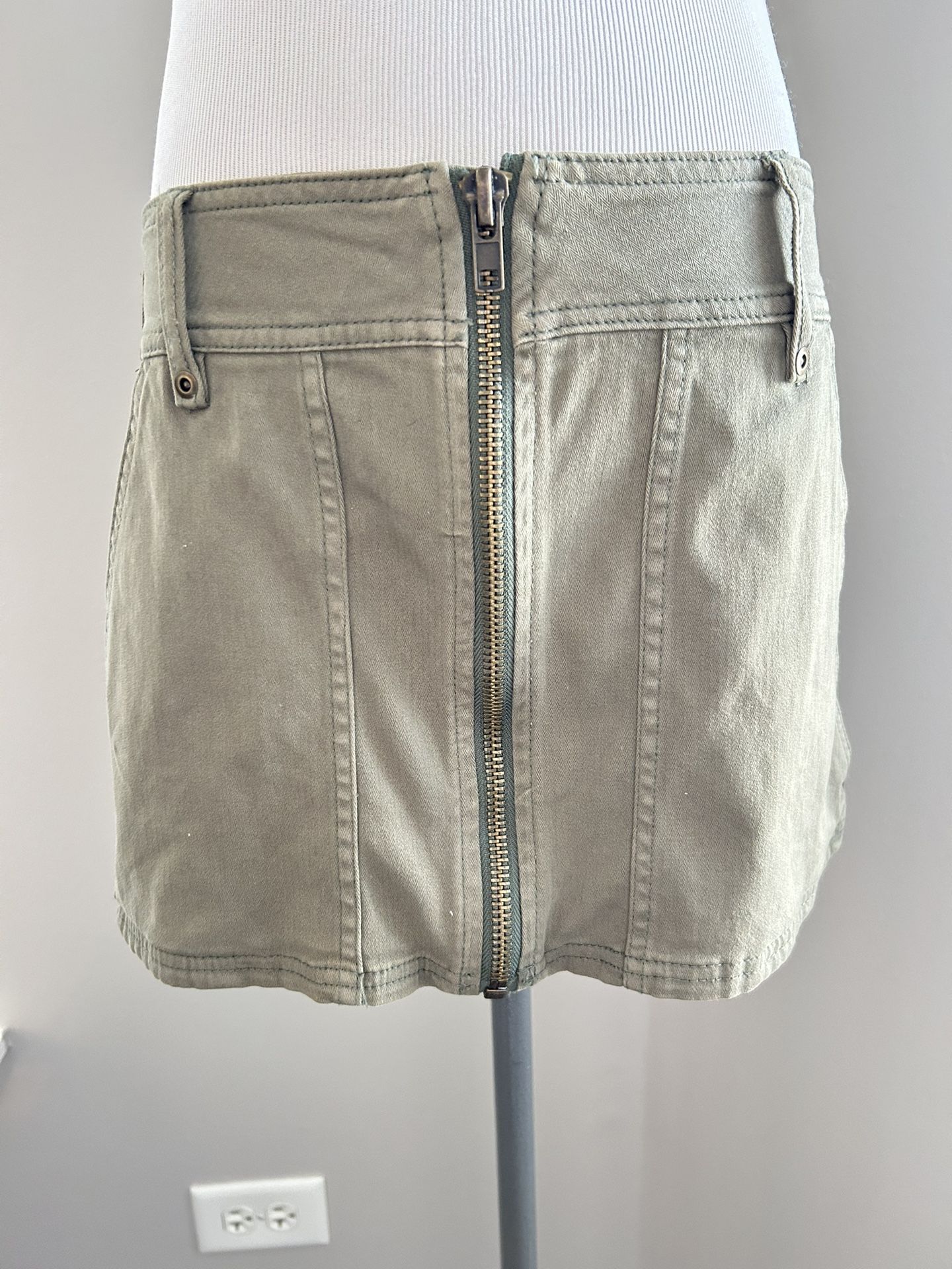 Woman’s army green zip from bottom to top in front Designer Free people size 2 jeans skirt
