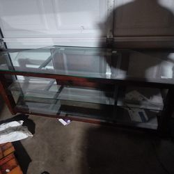 Real good condition tv stand 58 inches long 20 inches wide and 21 inches high