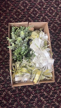 Box of wedding table greenery and bows