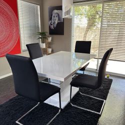 Contemporary dining table with 4 black chairs And Covers