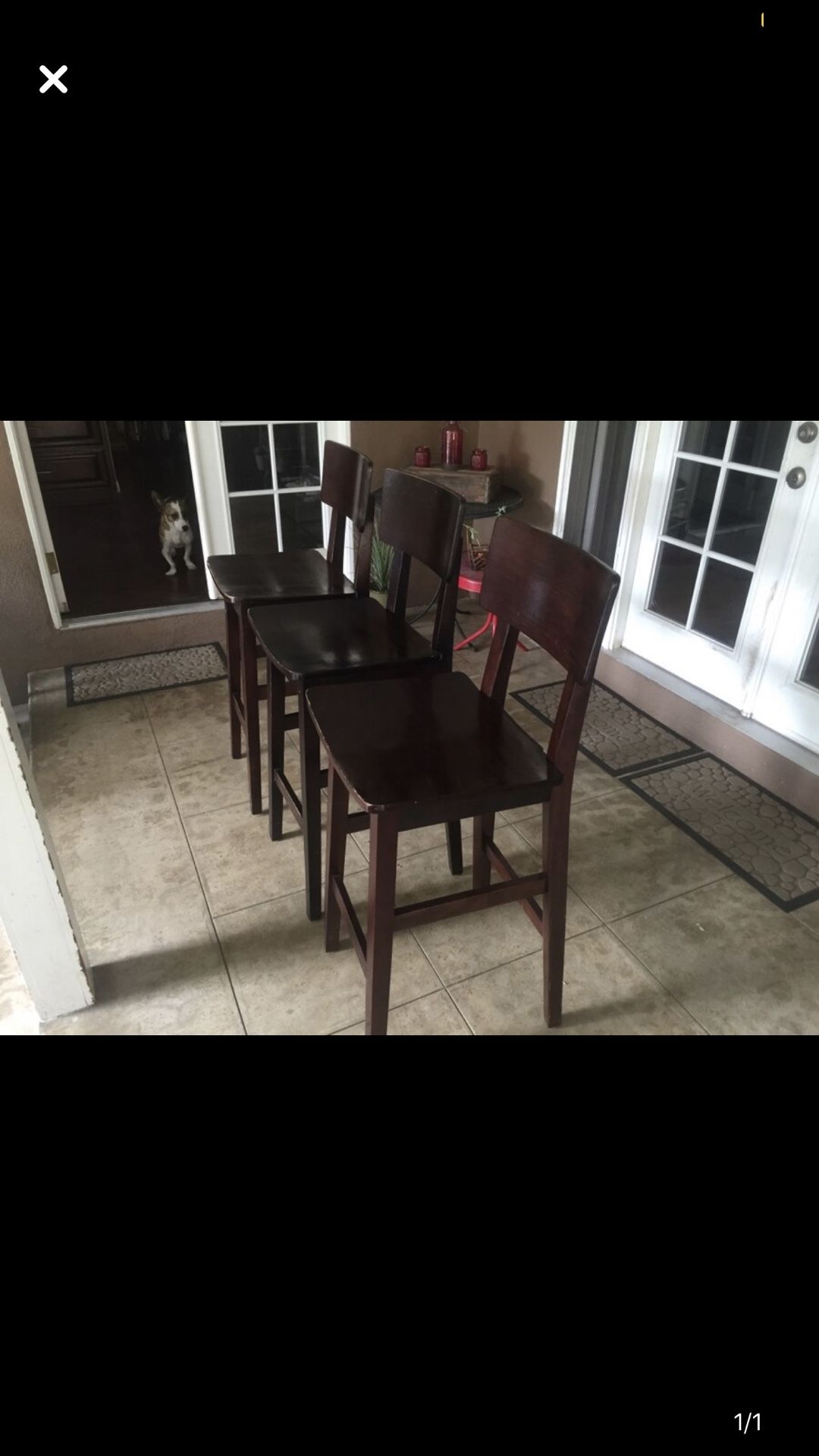 Three brown wooden stools