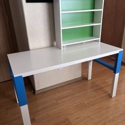 Multicolored desk with filing cabinets.
