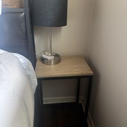 2 nightstands with lamps that include outlets