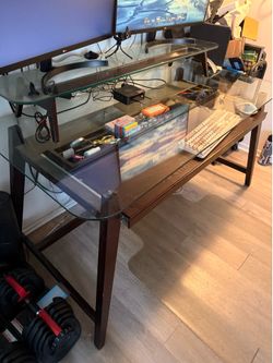 Selling vintage wooden desk with pull out shelf and two tier glass panels.