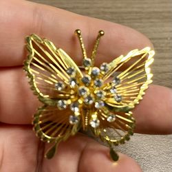gold tone vintage butterfly brooch is adorned with sparkling accents, perfect for adding a touch of elegance to any outfit. As is. No re