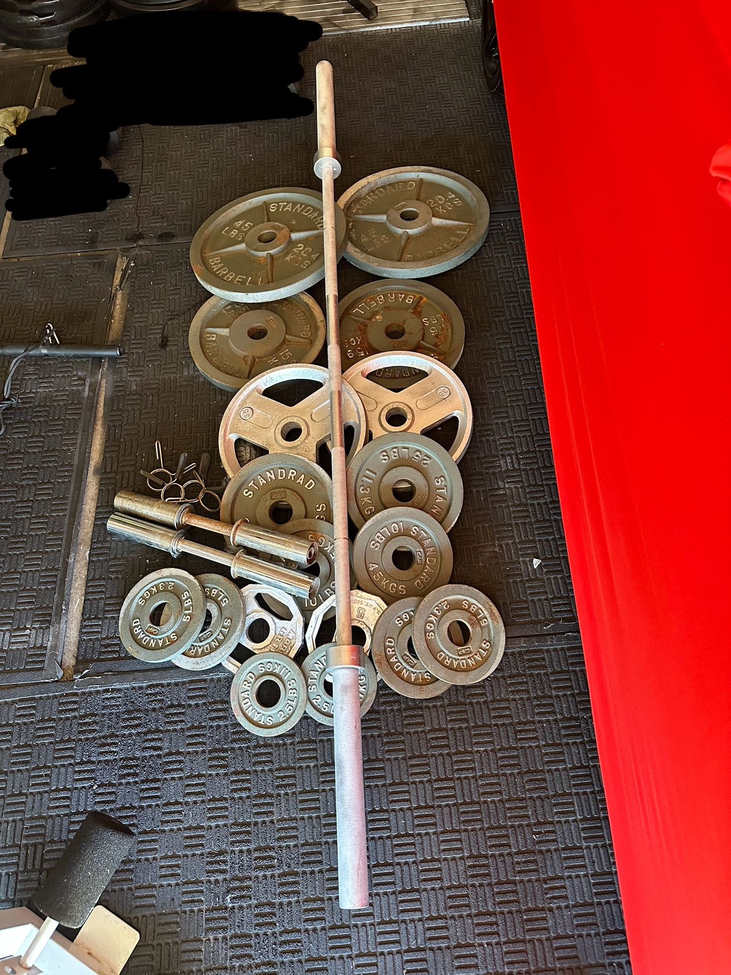 Olympic weight plates 335lbs with 7ft 40lbs Olympic bar and dumbbell handles 