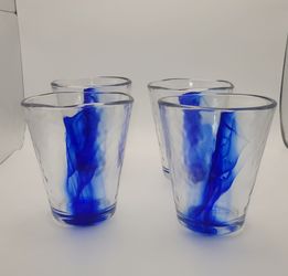 Set of 4 - 14 oz Bormioli Rocco Murano Cobalt Blue Beverage Glass, characterized by its free-flowing blue swirl detail and handmade-style uneven edge 