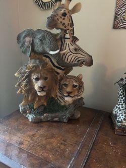 African wildlife sculpture, featuring a stacked design giraffe, zebra, lion, and tiger,