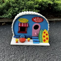 wooden birdhouse of a surf shop at the beach
