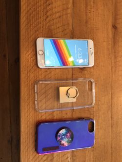 iPhone 8 with 2 phone cases and pop sockets