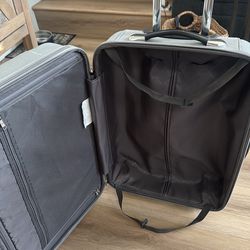 Gray suitcase with wheels and handle
