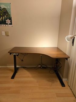 L-shaped wooden office desk - automatic standing desk
