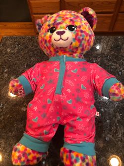 Build A Bear Workshop Teddy Bear Wearing a Pair if cute one piece pajamas .  .  Very cute.  Size 15 inches tall.  Preowned excellent condition.  Only 