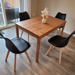 Brown Wooden Table and 4 Black chairs with attached seat  cushions