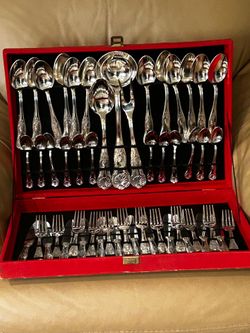 Silver coated flatware with serving pieces in red case