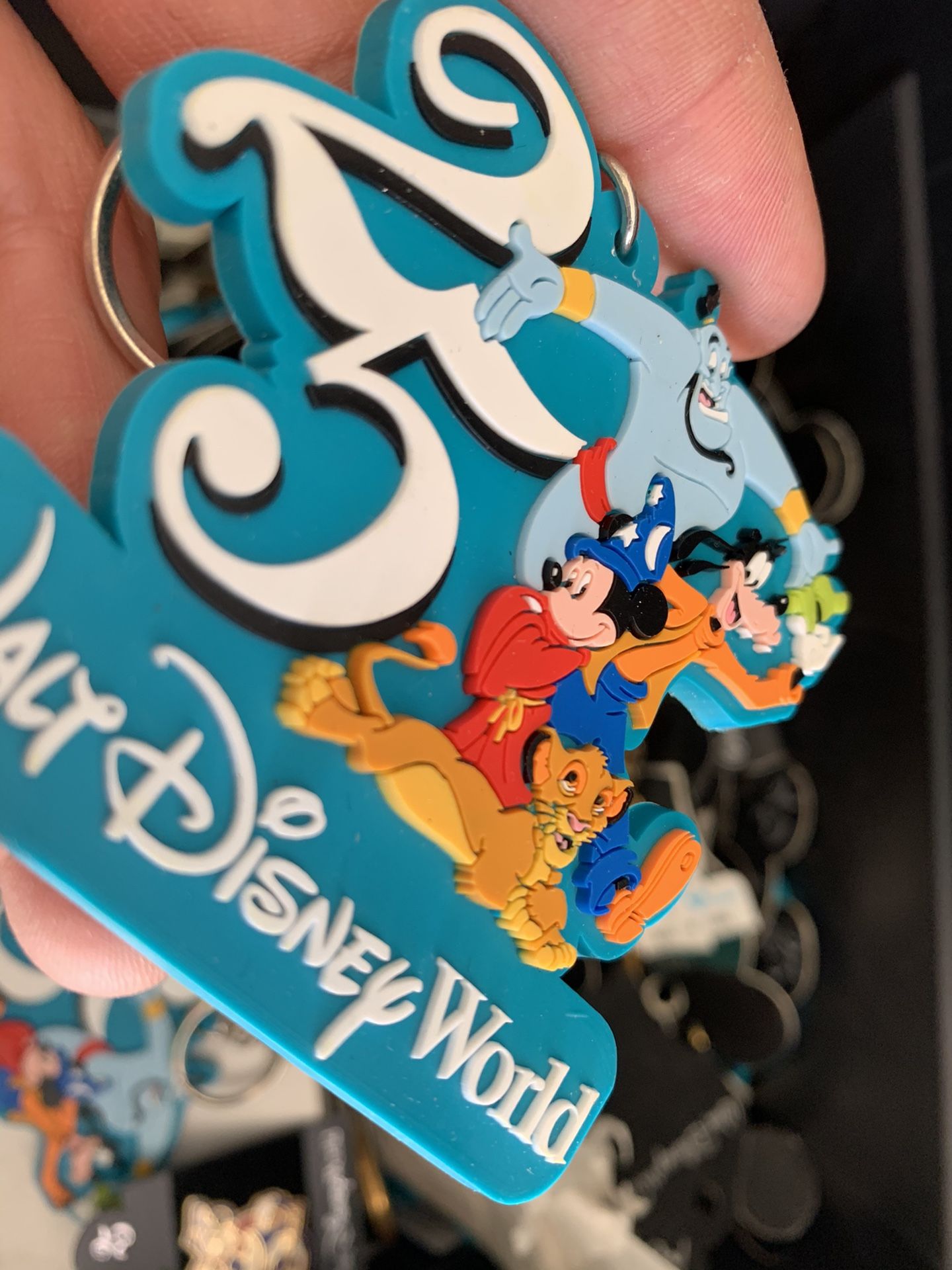 Box full of old Disney key chains and pins.