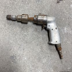 Old ad drill with wire brush attachment