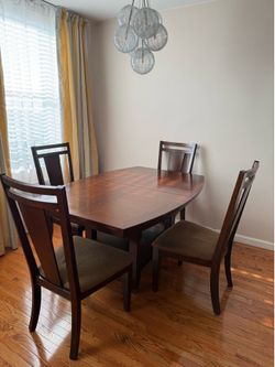 wooden extendable dining table with four chairs- $500